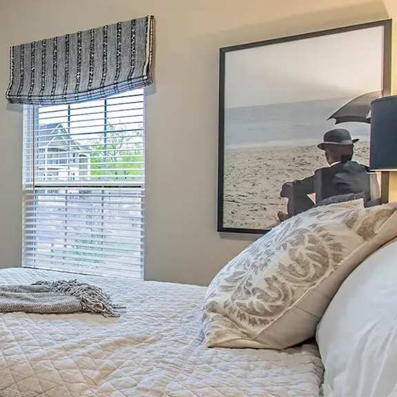 a bedroom with a bed and a closet and a window
