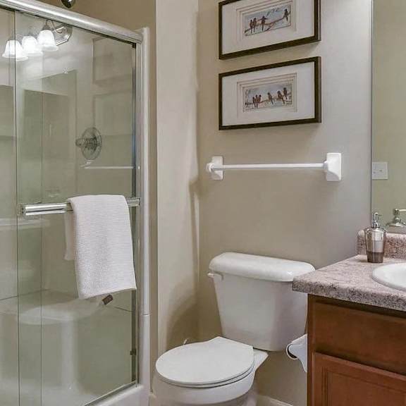 a bathroom with a toilet sink and a shower