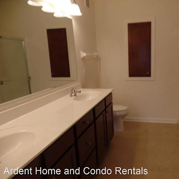 a bathroom with a sink and a mirror and a toilet