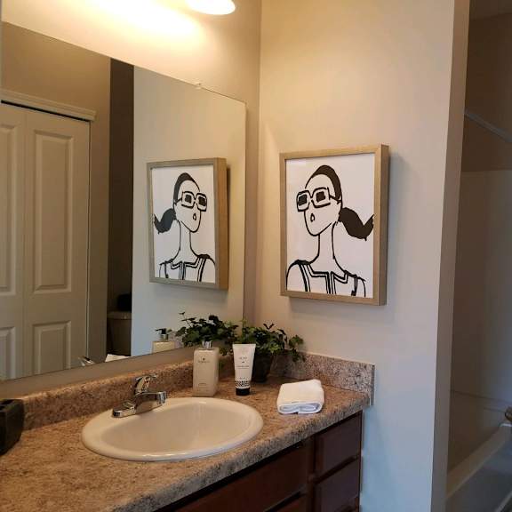 a bathroom with a sink and a mirror and a shower