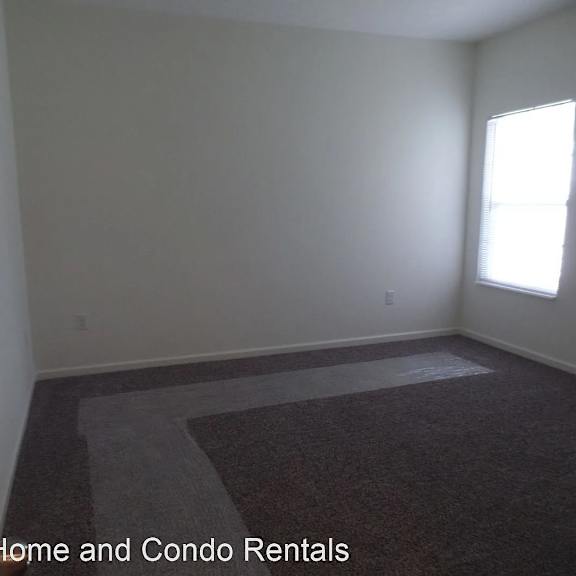 an empty room with white walls and a window