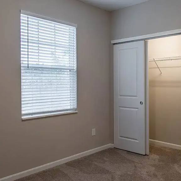 a room with two closets and a window and a door