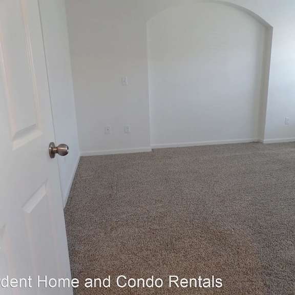 an empty room with a gray floor and a door