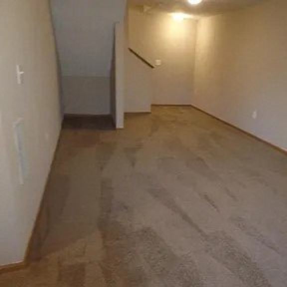 a room with a hard wood floor and white walls