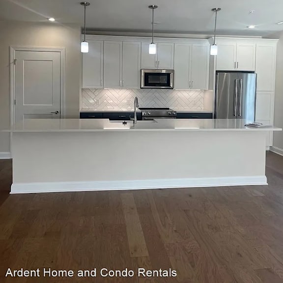 a kitchen with white cabinets and a white counter top