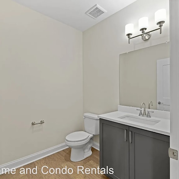 a bathroom with a toilet and a sink and a mirror
