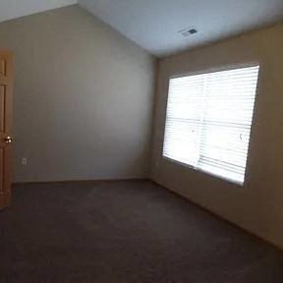 an empty room with a door and a window