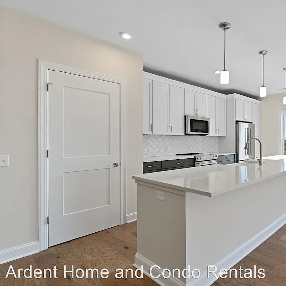 a kitchen with white cabinets and a white counter top