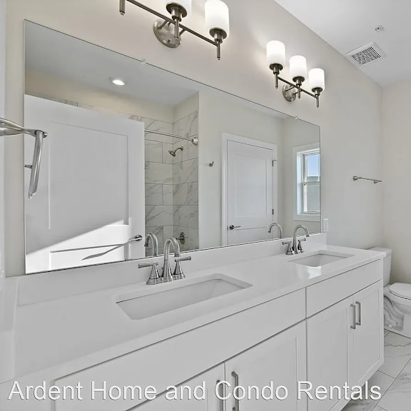 a bathroom with a sink and a toilet and a mirror