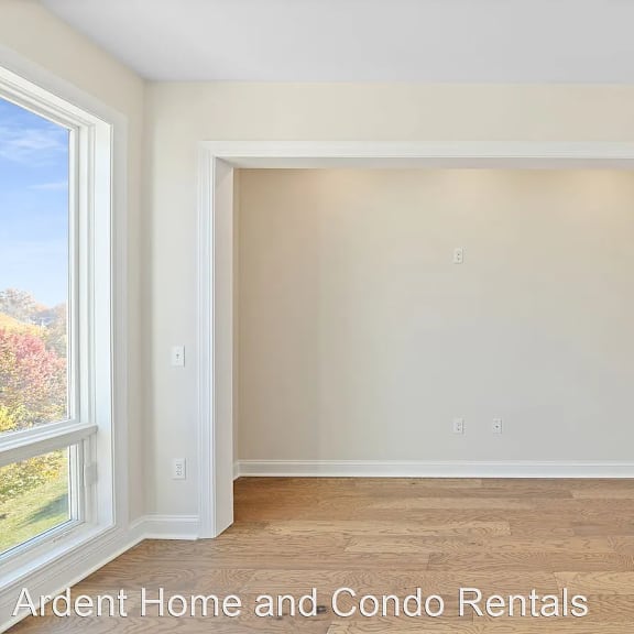 a empty room with white walls and a wooden floor