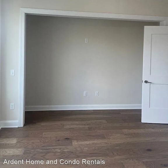 an empty room with a ceiling fan and a door