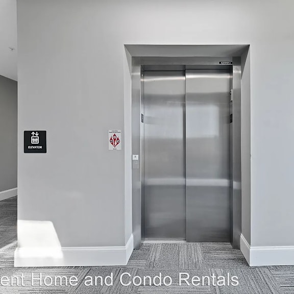 an empty hallway with an elevator in a building