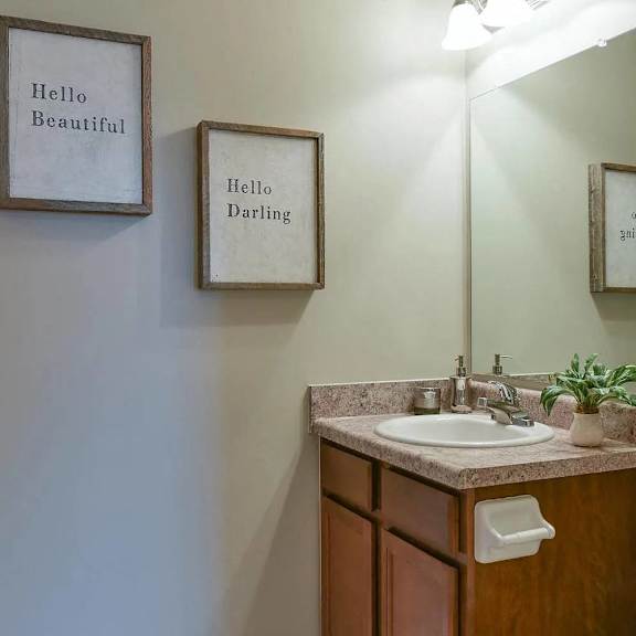a bathroom with a sink and a mirror and a toilet