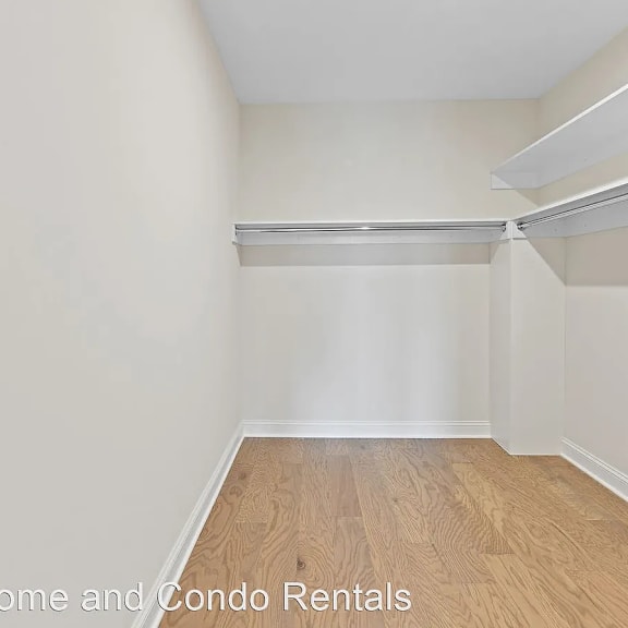 a empty room with a wooden floor and white walls