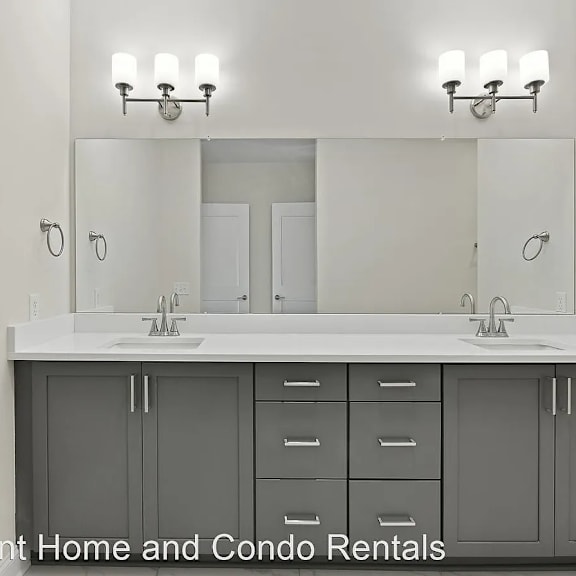 this bathroom has two sinks and two mirrors in it