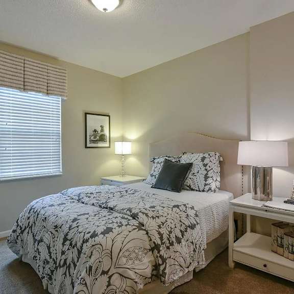 a bedroom with a bed and a night stand
