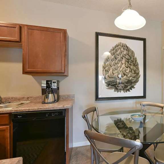a dining room with a glass table and chairs