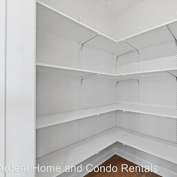the inside of an empty white shelf in a closet