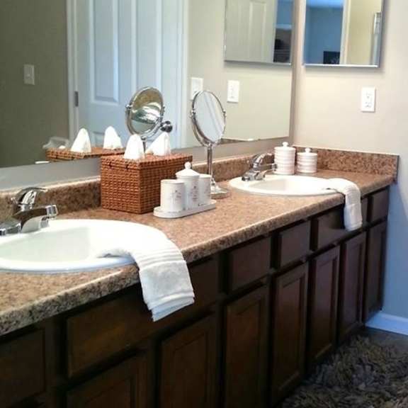 a bathroom with two sinks and a mirror.
