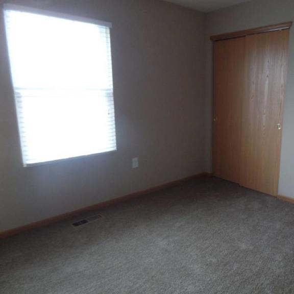 an empty room with a window and a door