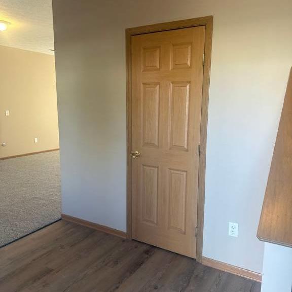 an empty room with a wooden door