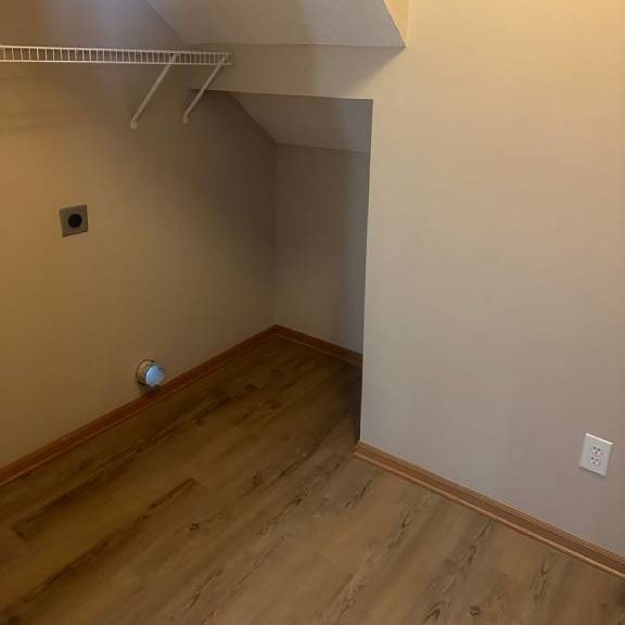 a empty room with a closet and a wooden floor