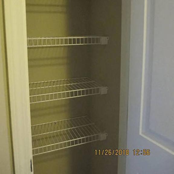 empty shelves in a white refrigerator.