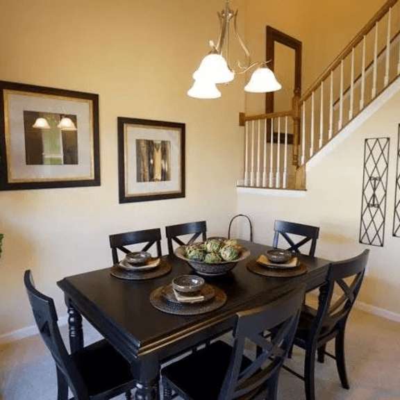 a dining room with a table set for four.