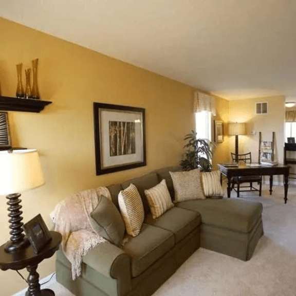 a living room with a couch, a table, and a chair.