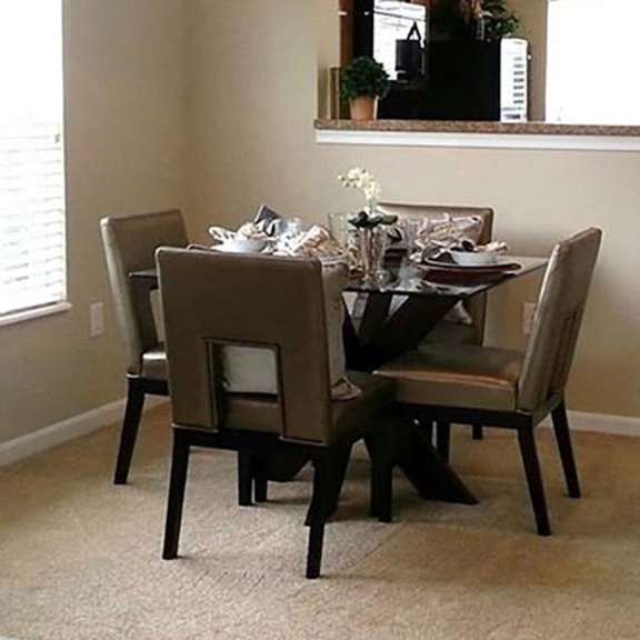 a dining room with a table set for four.