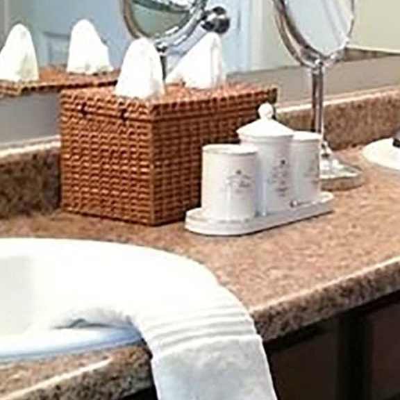a bathroom with a brown counter top and a white sink.