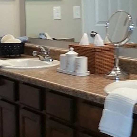 a bathroom with a brown counter top and a white sink.