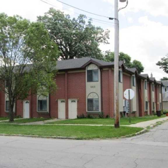 an apartment building on the corner of a street