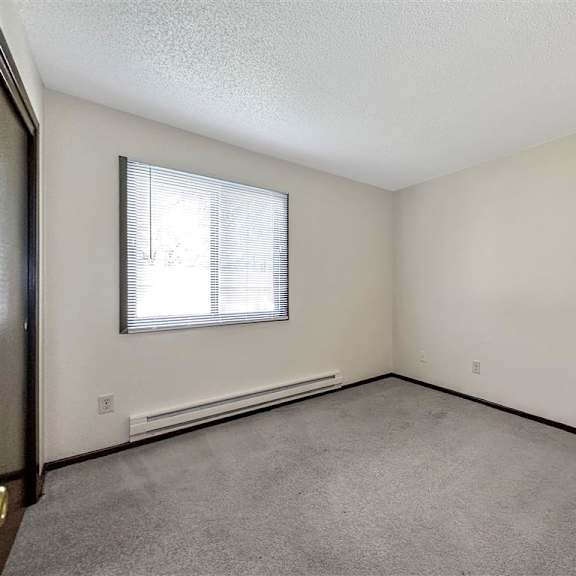 the living room of an empty house with a window