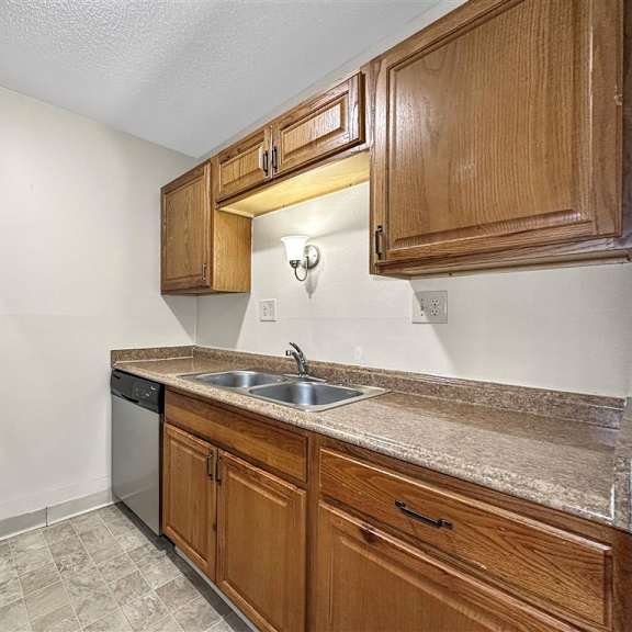 a kitchen with a sink and a refrigerator