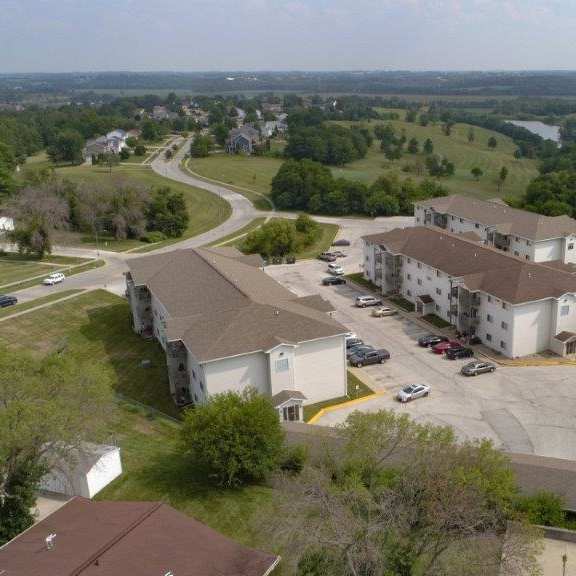 an aerial view of a neighborhood with houses and a road