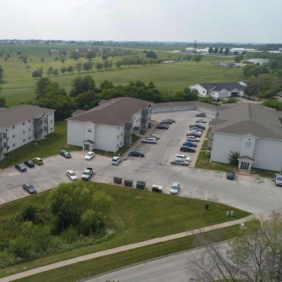 an aerial view of some buildings and a parking lot