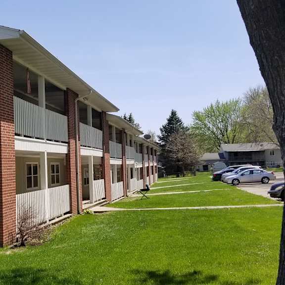 a brick building with a sidewalk in front of it