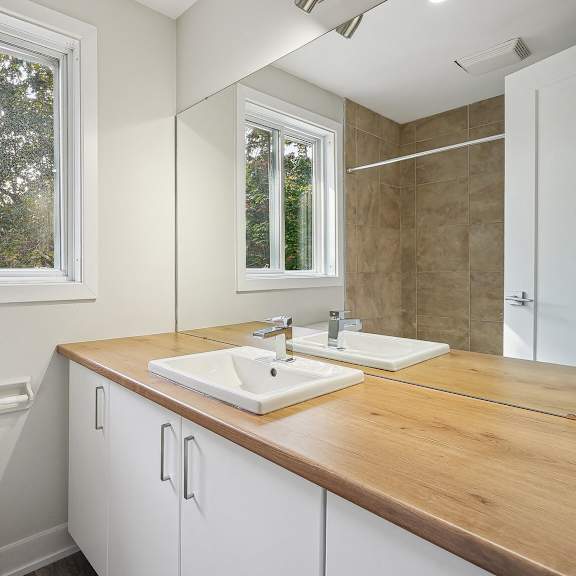 a bathroom with a toilet, sink, and mirror.