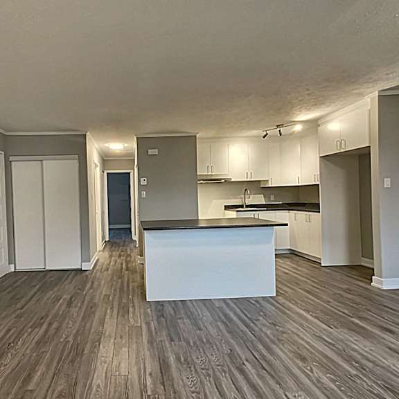 a kitchen with a white island in the middle of the room.