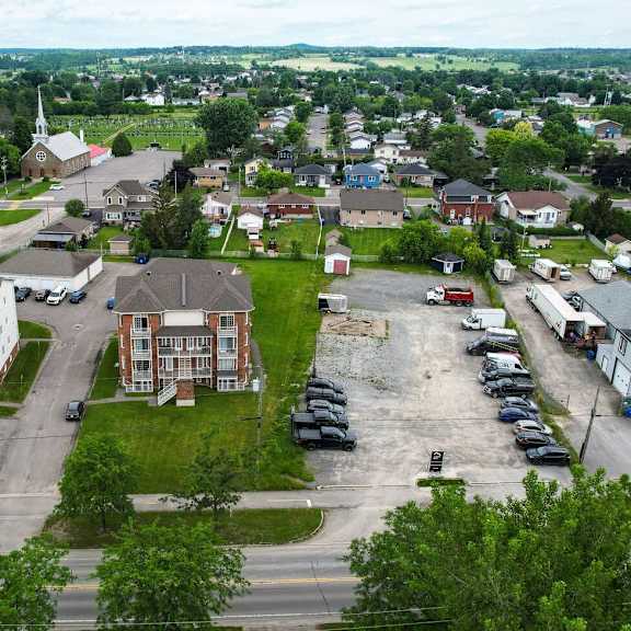 a bird's eye view of a residential area with a church and apartment buildings.