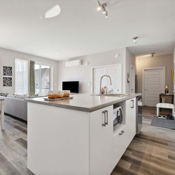 a modern kitchen with a dining table and chairs.