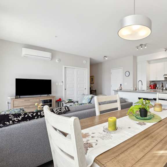 a modern kitchen with a dining table and chairs.