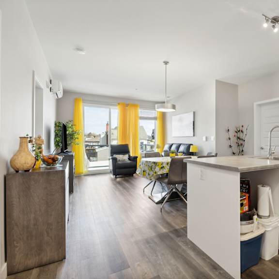 a modern kitchen with white cabinets and a wooden island.
