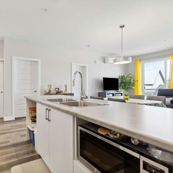 a modern kitchen with white cabinets and stainless steel appliances.