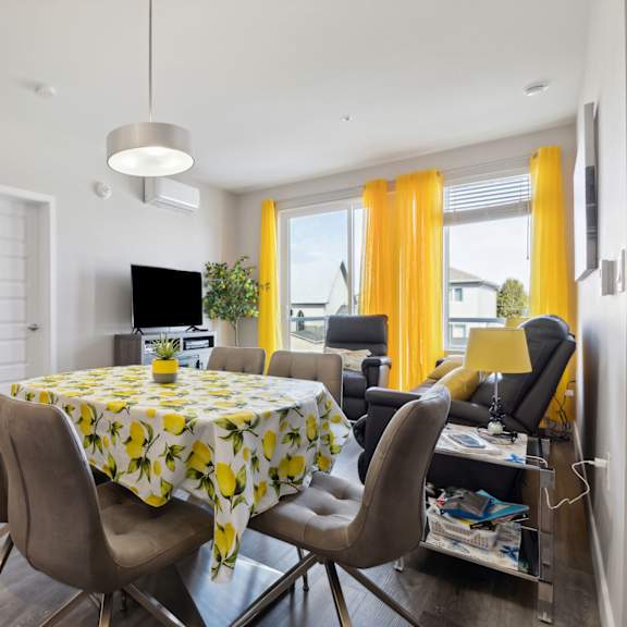 a dining room with a table set for four.