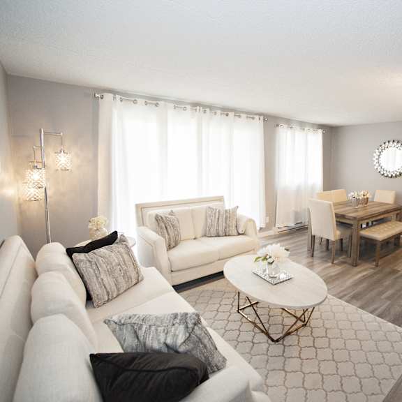 a living room with a white couch and a coffee table.