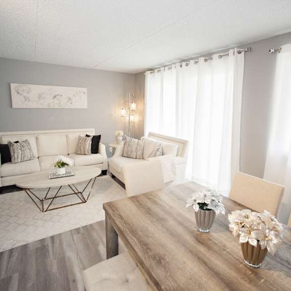 a living room with a white sofa and a wooden coffee table.