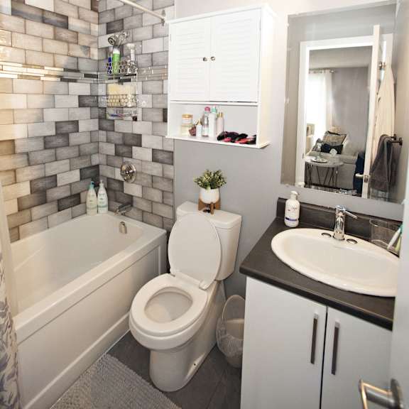 a bathroom with a white toilet, a white sink, and a white bathtub.