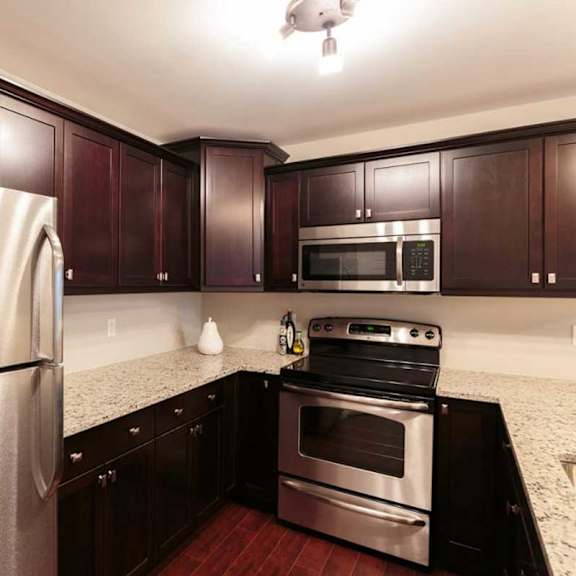 a kitchen with a stainless steel refrigerator and a stainless steel oven.